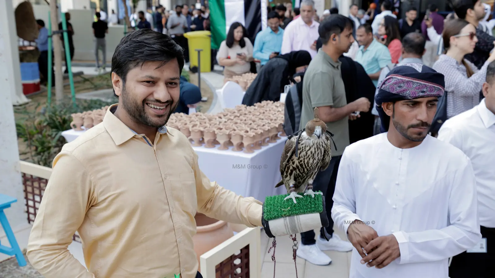 Guest participating in a traditional falcon cultural experience during the Dubai Airport Freezone UAE National Day celebration in Dubai