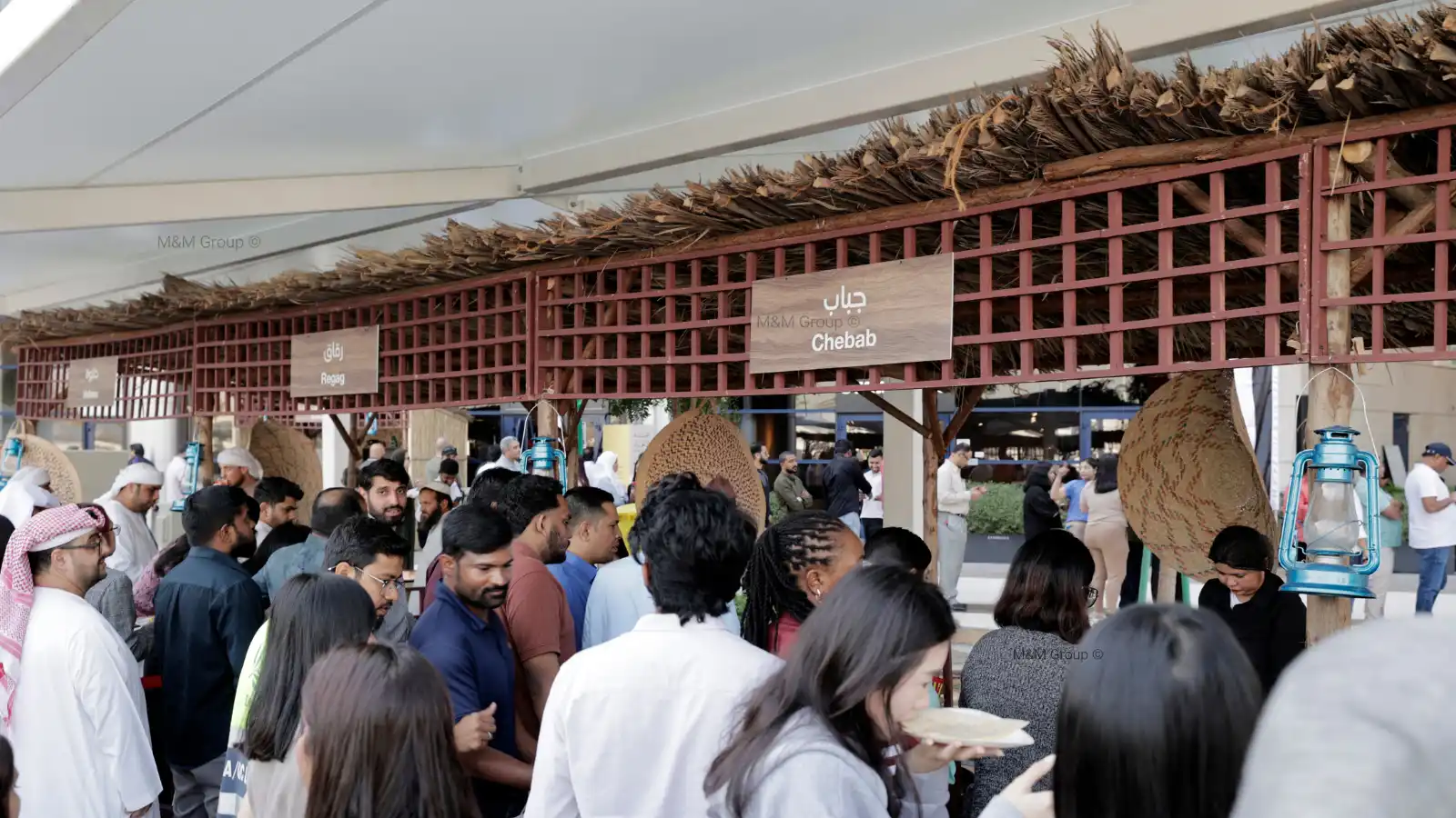 Guests visiting a traditional Emirati food market activation during the Dubai Airport Freezone UAE National Day celebration in Dubai