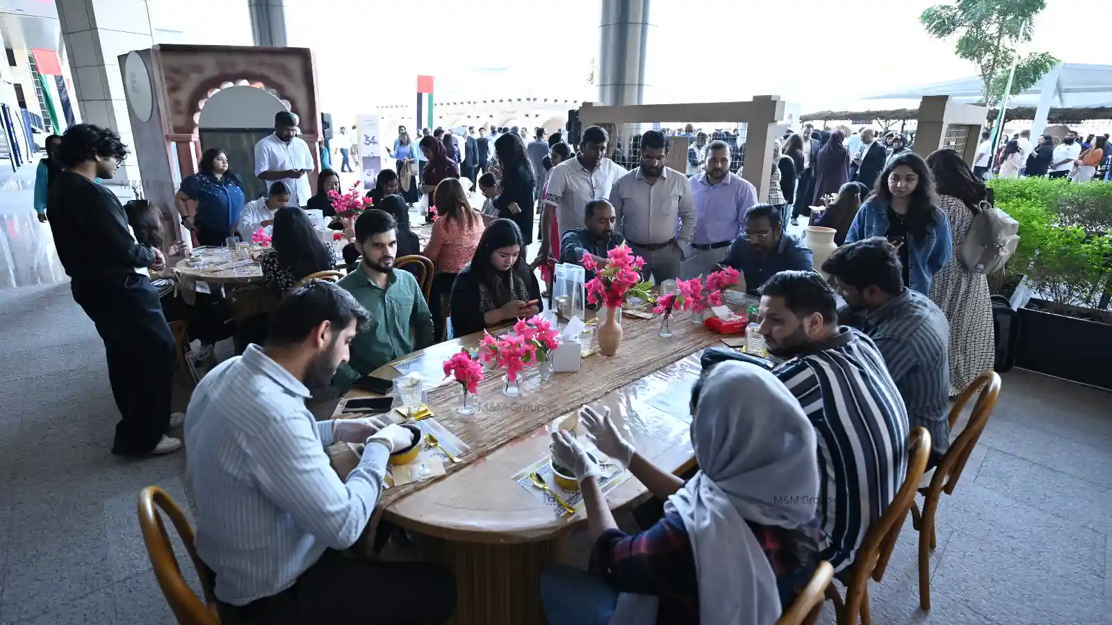Guests participating in a traditional bakhoor making workshop during the Dubai Airport Freezone UAE National Day celebration in Dubai
