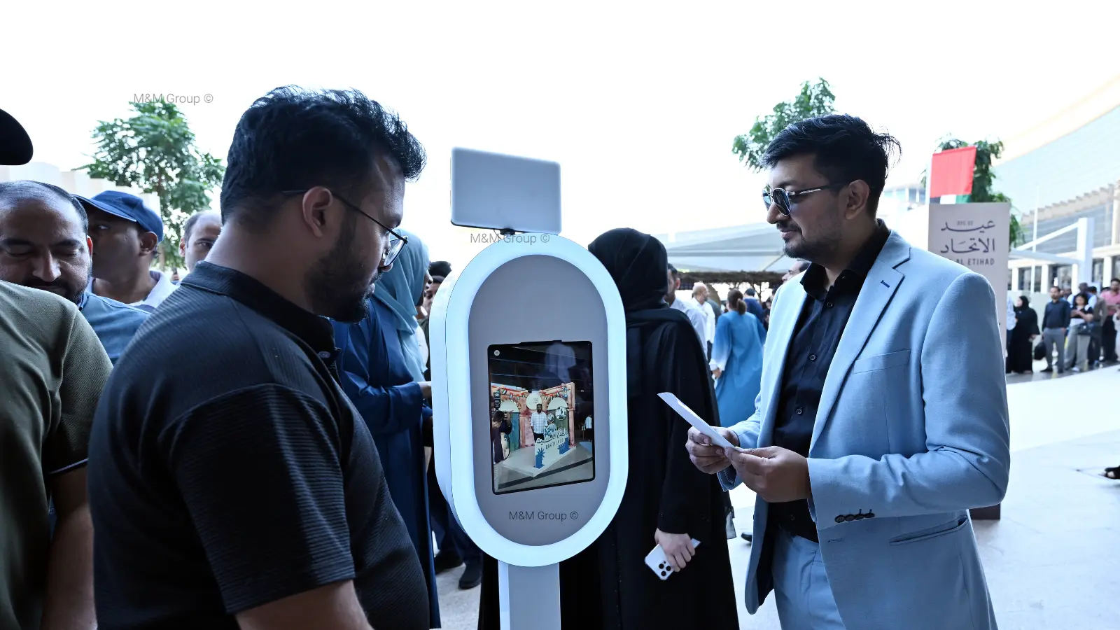 Guests interacting with a branded digital photo booth activation during the Dubai Airport Freezone UAE National Day celebration event