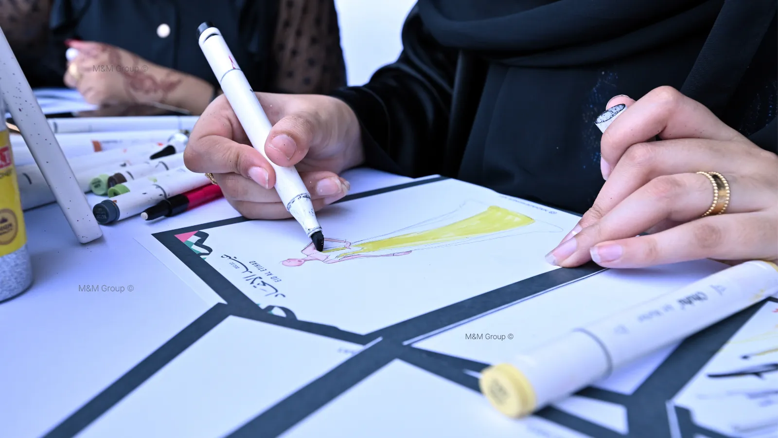 Live sketch artist activity during the Dubai Airport Freezone UAE National Day celebration event featuring traditional Emirati fashion illustration