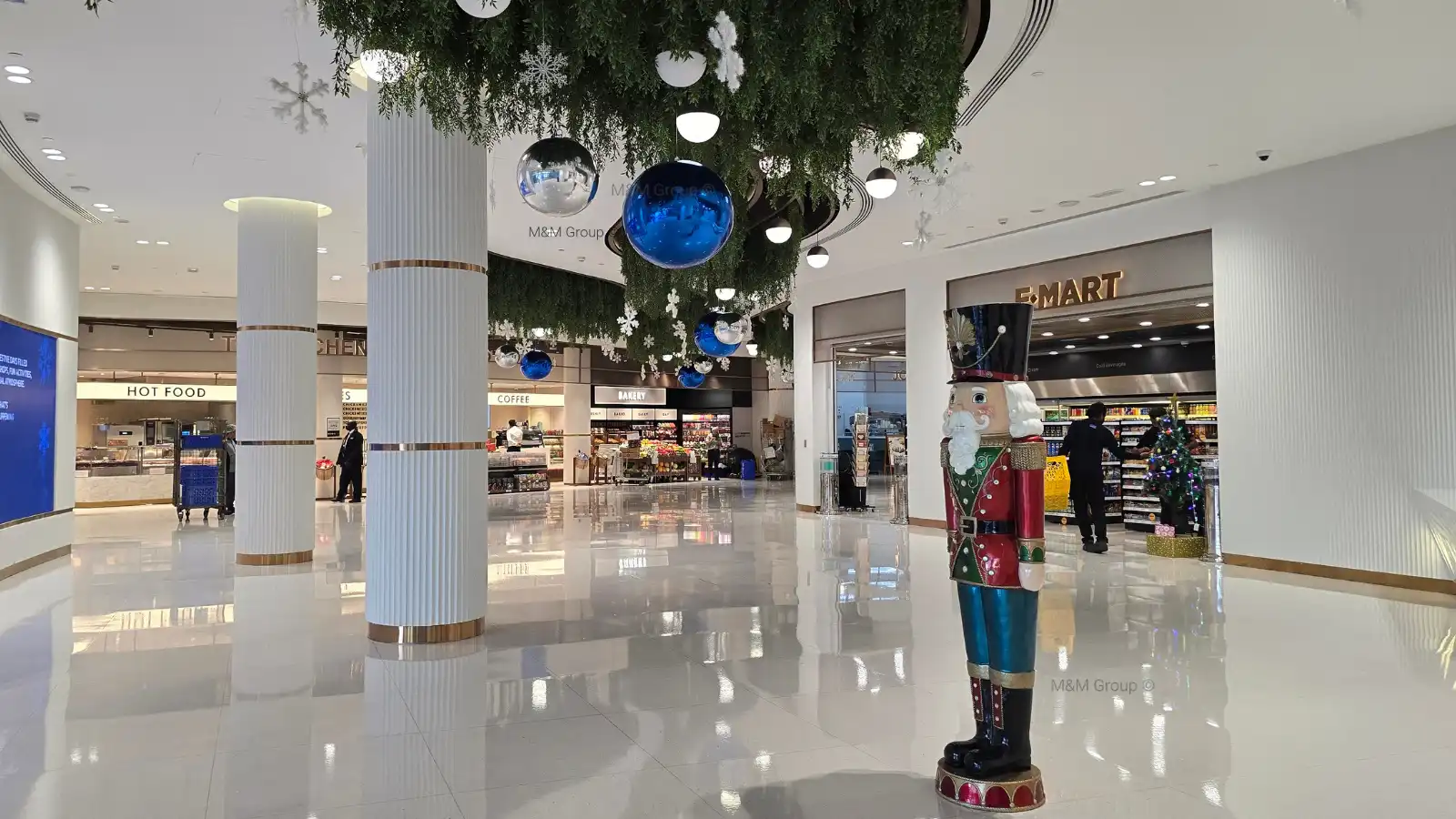 DAFZ Winter Festival food court décor with hanging blue and silver ornaments, snowflakes, and nutcracker display in Dubai